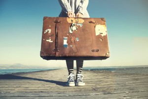 young woman ready to travel with her suitcase